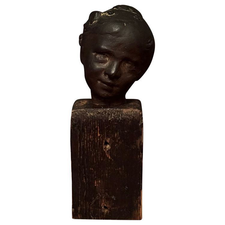 Studio plaster by Charles Filleul depicting a young boy on a wooden base